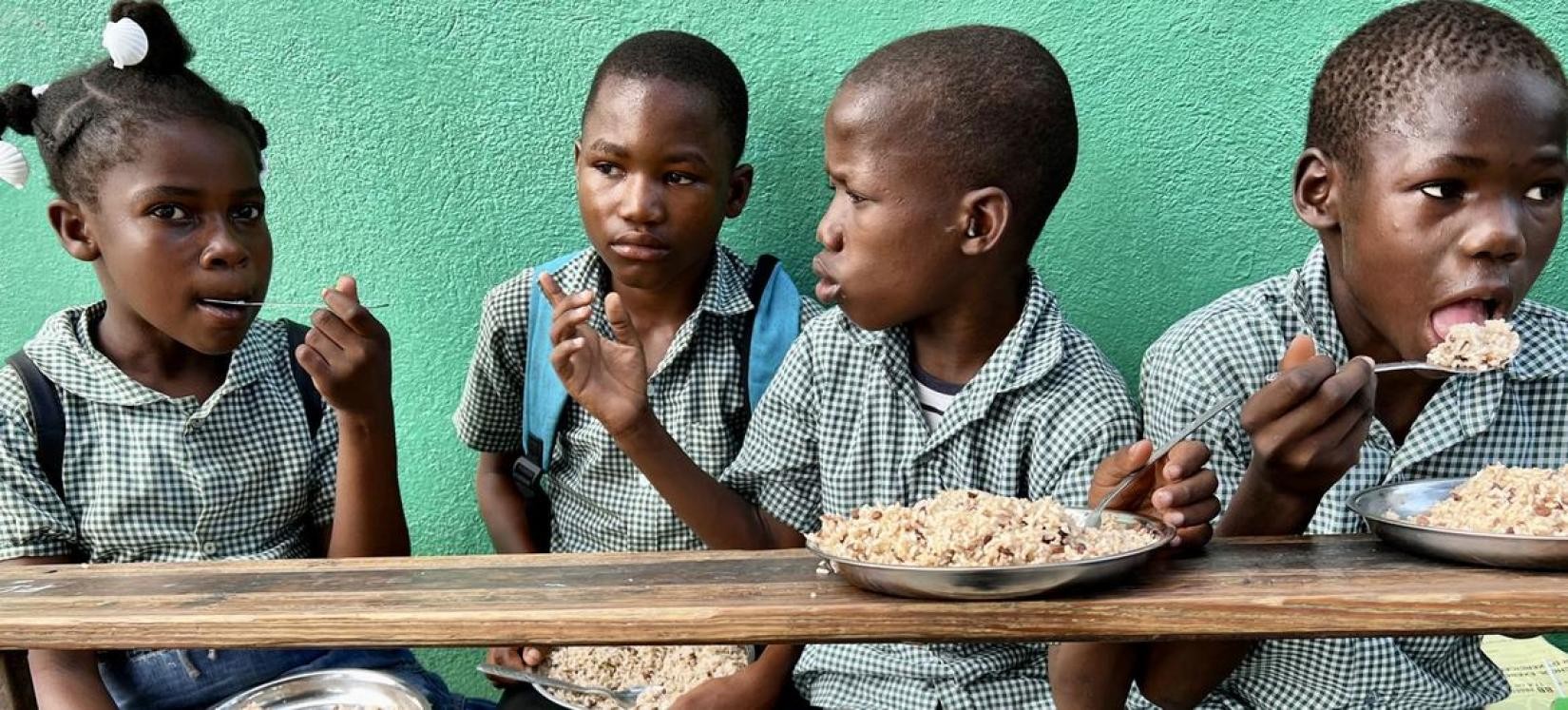 Children share a school meal in Haiti